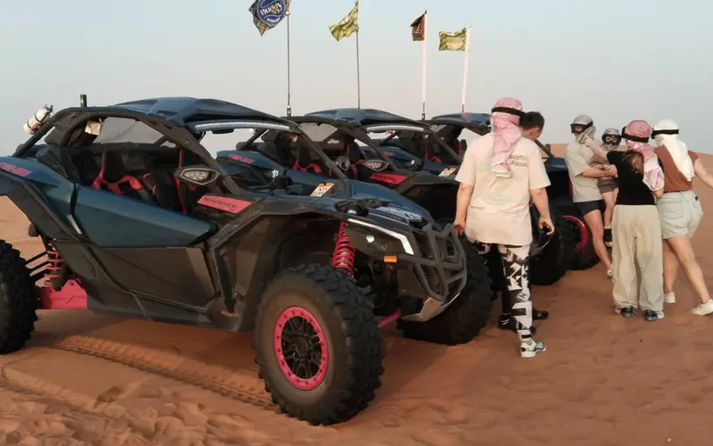 Can-Am Maverick dune buggy on red dunes Dubai